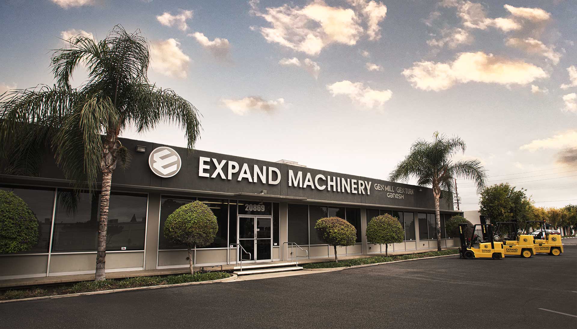 ExpandMachinery_BuildingFront Exterior of building with a low angle perspective showing a sky with clouds