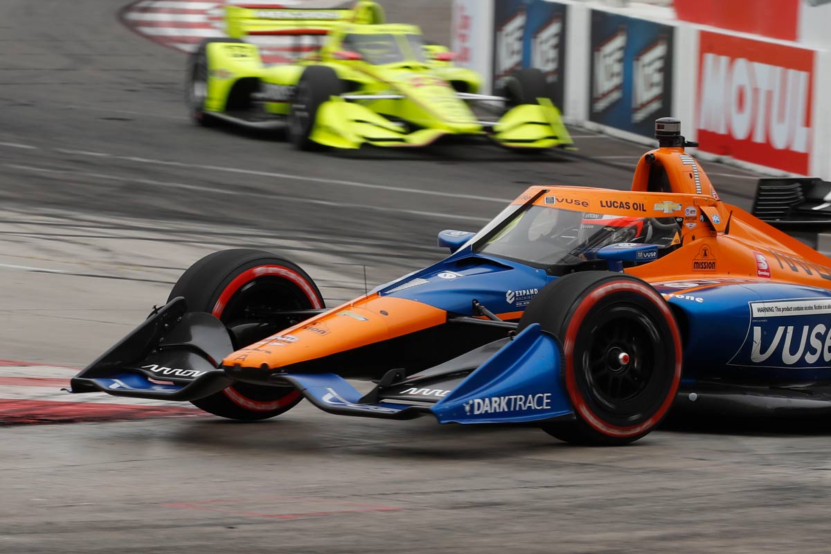 Expand_Racecar_2021_01 Orange and Blue racecar with yellow car in the background