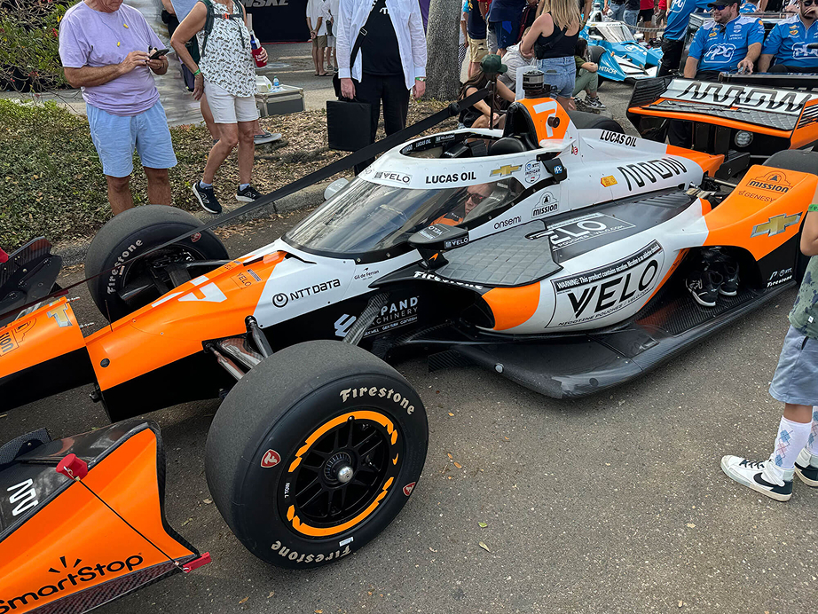 Orange and black nascar with an expand machinery sponsorship logo